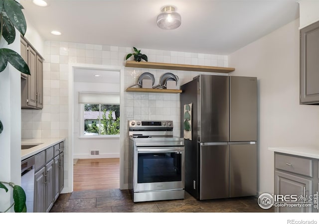 7850 Raleigh Pl, Westminster, CO 80030 - kitchen with stainless steel appliances, gray cabinetry, backsplash, open shelves, and recessed lighting