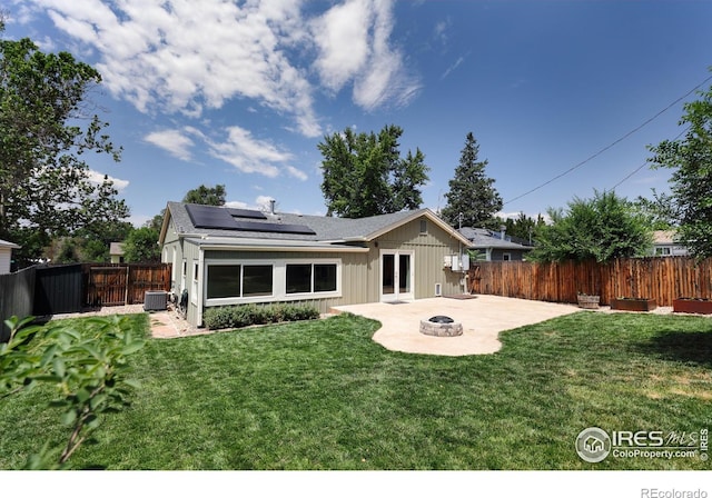 7850 Raleigh Pl, Westminster, CO 80030 - back of property featuring a fire pit, a patio, solar panels, a fenced backyard, and board and batten siding