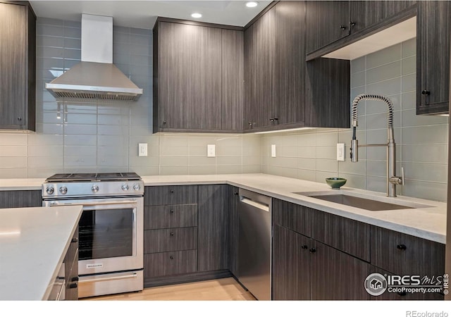 2718 Pine St Unit 301, Boulder, CO 80302 - kitchen with wall chimney range hood, stainless steel appliances, decorative backsplash, dark brown cabinets, and recessed lighting