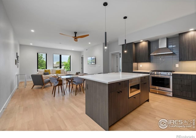 2718 Pine St Unit 301, Boulder, CO 80302 - kitchen with wall chimney exhaust hood, appliances with stainless steel finishes, light wood finished floors, light countertops, and modern cabinets