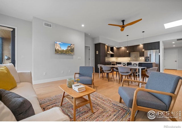 2718 Pine St Unit 301, Boulder, CO 80302 - living room with light wood-type flooring, ceiling fan, recessed lighting, and a skylight