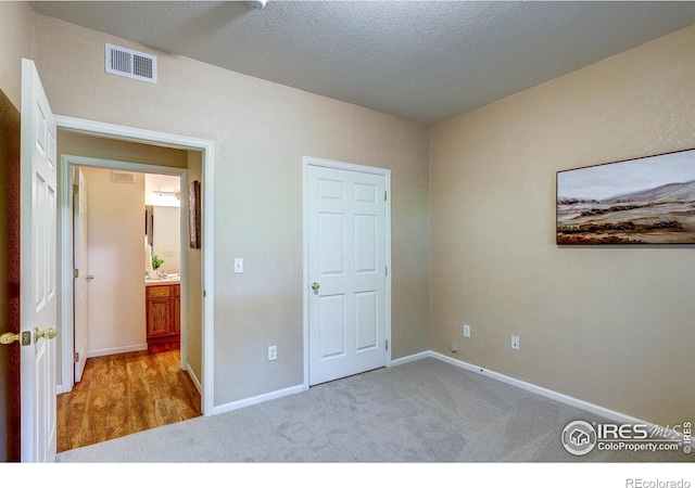 2131 Grays Peak Dr Unit 102, Loveland, CO 80538 - unfurnished bedroom featuring carpet and a textured ceiling