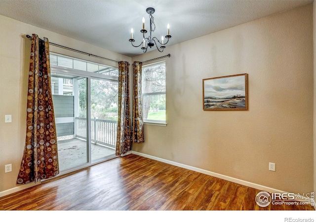 2131 Grays Peak Dr Unit 102, Loveland, CO 80538 - spare room featuring a chandelier and wood finished floors