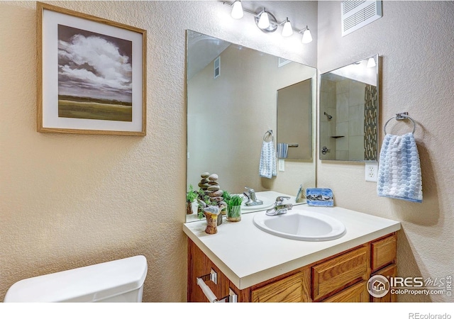 2131 Grays Peak Dr Unit 102, Loveland, CO 80538 - full bathroom featuring vanity, a textured wall, and a shower