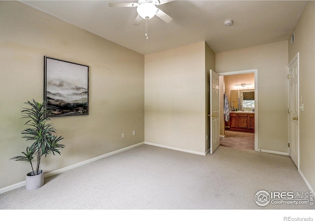 2131 Grays Peak Dr Unit 102, Loveland, CO 80538 - unfurnished bedroom with light carpet, ensuite bath, and a ceiling fan