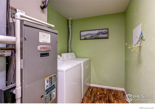 2131 Grays Peak Dr Unit 102, Loveland, CO 80538 - washroom featuring washer and dryer, wood finished floors, and heating unit
