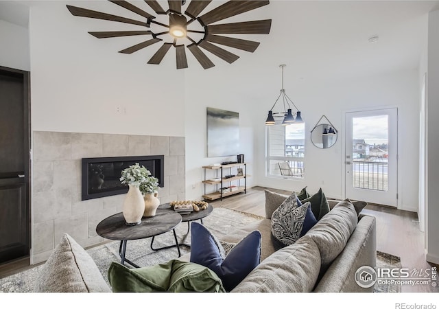 945 Abbott Ln Unit 2, Fort Collins, CO 80524 - living room featuring wood finished floors, a ceiling fan, and a tiled fireplace