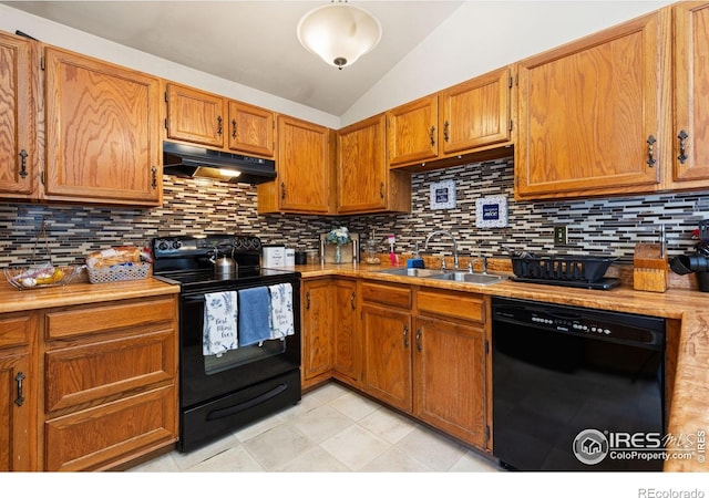 1200-1202 Parker Dr, Longmont, CO 80501 - kitchen with black appliances, under cabinet range hood, lofted ceiling, light countertops, and backsplash