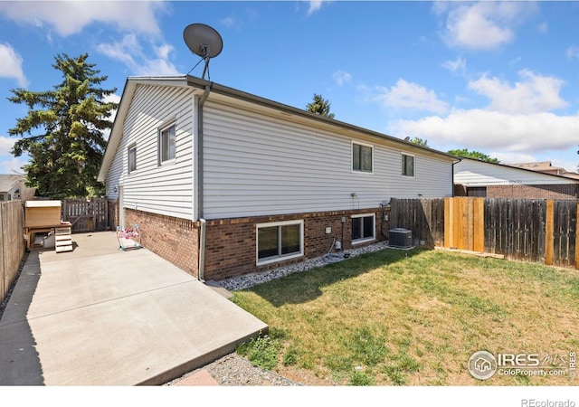 1200-1202 Parker Dr, Longmont, CO 80501 - back of property with brick siding, a fenced backyard, and a patio area