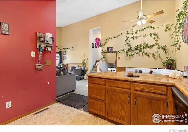 1200-1202 Parker Dr, Longmont, CO 80501 - kitchen featuring ceiling fan, brown cabinetry, light floors, light countertops, and open floor plan
