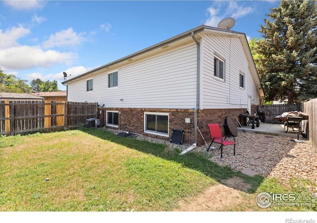 1200-1202 Parker Dr, Longmont, CO 80501 - back of house featuring a patio area, a fenced backyard, and brick siding