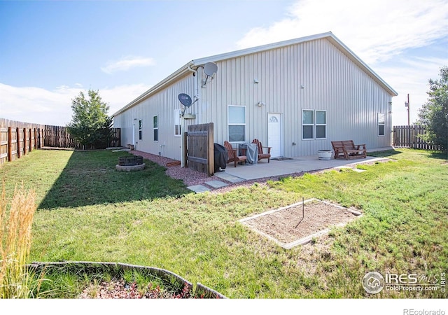 18441 Bandana Ln, Wellington, CO 80549 - rear view of property featuring a fenced backyard, a patio area, and board and batten siding