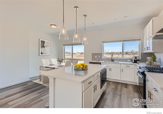 919 Schlagel St Unit 3, Fort Collins, CO 80524 - kitchen featuring gas range oven, light wood-style floors, light countertops, and decorative backsplash