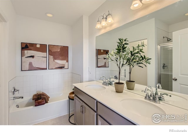 919 Schlagel St Unit 3, Fort Collins, CO 80524 - bathroom featuring double vanity, a garden tub, a stall shower, and recessed lighting