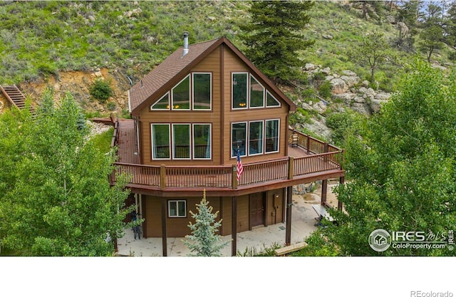228 Mount Everest Dr, Livermore, CO 80536 - back of property featuring a patio and a deck