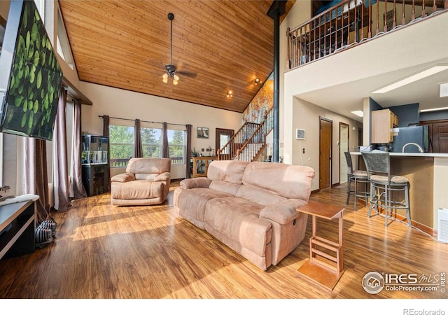 228 Mount Everest Dr, Livermore, CO 80536 - living room with high vaulted ceiling, wood finished floors, ceiling fan, stairway, and wooden ceiling