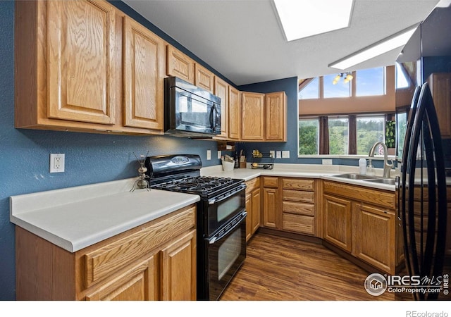 228 Mount Everest Dr, Livermore, CO 80536 - kitchen featuring black appliances, dark wood-style flooring, and light countertops