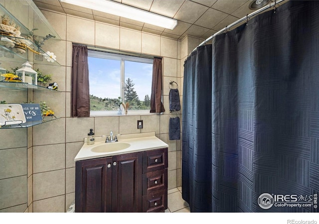 228 Mount Everest Dr, Livermore, CO 80536 - full bathroom featuring tile walls, vanity, and a shower with curtain