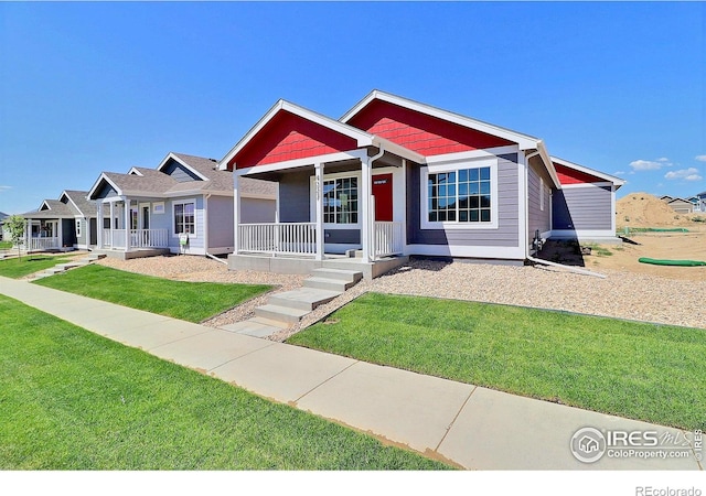 4327 Primrose Ln, Evans, CO 80620 - view of front of home with a porch and a front yard