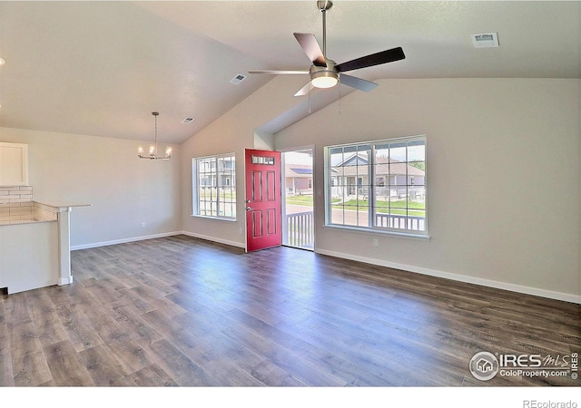 4327 Primrose Ln, Evans, CO 80620 - unfurnished living room featuring a chandelier, ceiling fan, dark wood finished floors, and vaulted ceiling