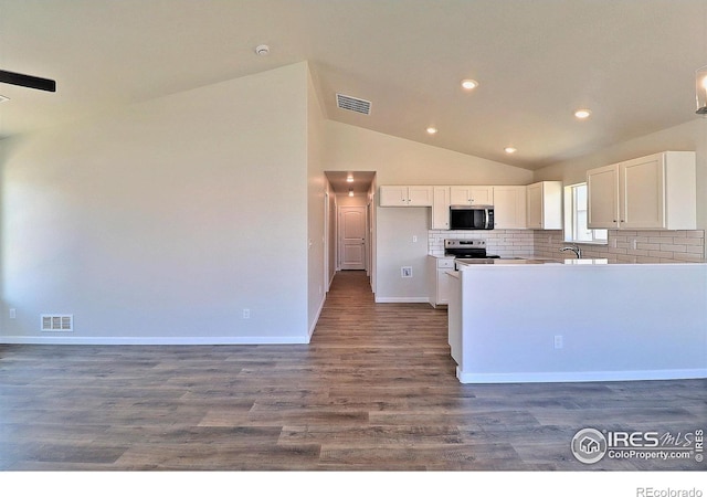 4327 Primrose Ln, Evans, CO 80620 - kitchen with appliances with stainless steel finishes, white cabinets, lofted ceiling, tasteful backsplash, and recessed lighting