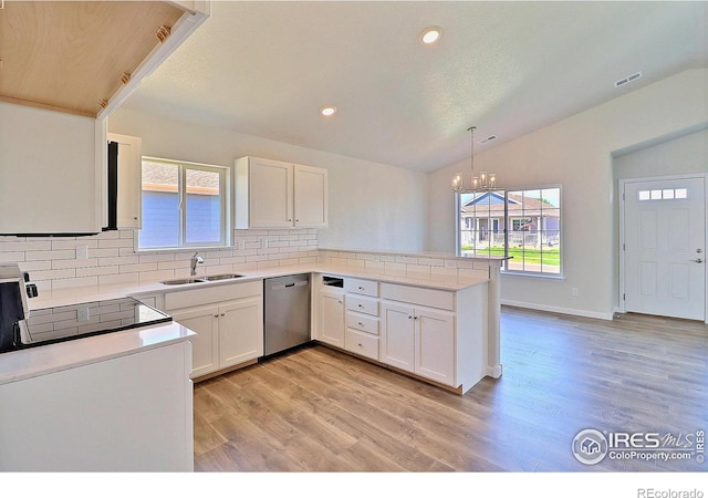 4327 Primrose Ln, Evans, CO 80620 - kitchen featuring dishwasher, vaulted ceiling, a peninsula, decorative backsplash, and a chandelier