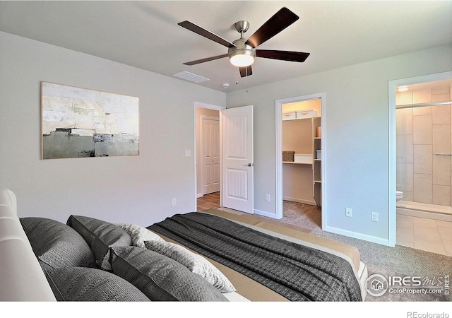 4327 Primrose Ln, Evans, CO 80620 - carpeted bedroom featuring a walk in closet, ensuite bath, and ceiling fan