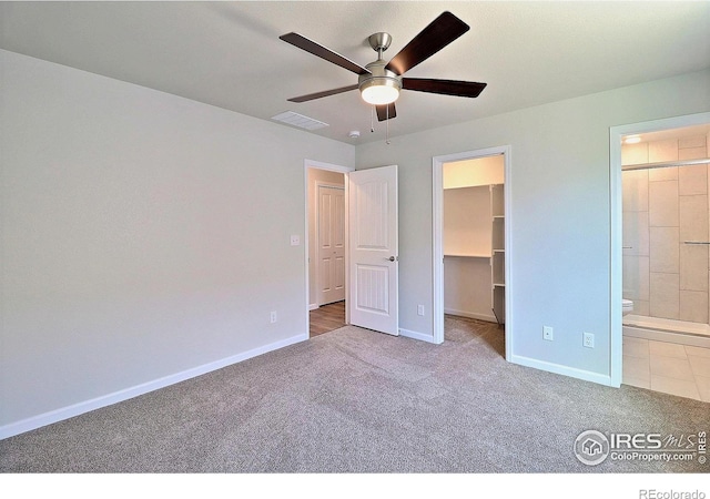 4327 Primrose Ln, Evans, CO 80620 - unfurnished bedroom featuring carpet, a walk in closet, connected bathroom, and ceiling fan