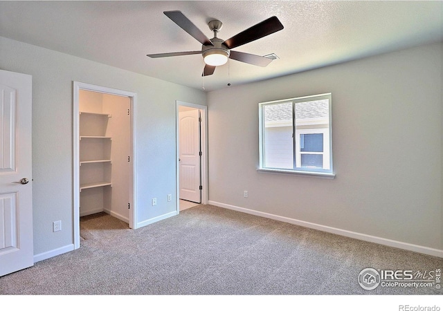 4327 Primrose Ln, Evans, CO 80620 - unfurnished bedroom featuring carpet, a spacious closet, and ceiling fan