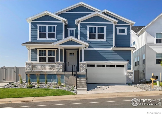 900 Eldorado Ln, Louisville, CO 80027 - craftsman-style home with stone siding, a garage, concrete driveway, and covered porch