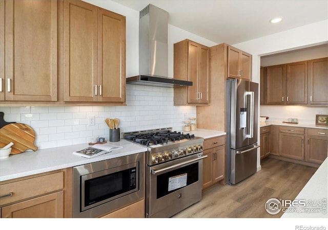 900 Eldorado Ln, Louisville, CO 80027 - kitchen with wall chimney range hood, high end appliances, light wood-style flooring, and light countertops