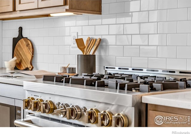 900 Eldorado Ln, Louisville, CO 80027 - kitchen view of decorative backsplash, stove, and light countertops