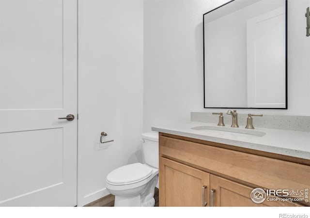 900 Eldorado Ln, Louisville, CO 80027 - half bathroom featuring vanity and wood finished floors