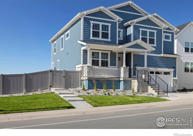 900 Eldorado Ln, Louisville, CO 80027 - craftsman-style house with an attached garage, covered porch, a gate, concrete driveway, and stone siding