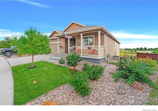 1774 Thrive Dr, Windsor, CO 80550 - view of front of home with a porch, concrete driveway, an attached garage, and a front yard