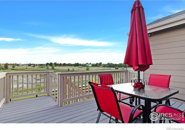 1774 Thrive Dr, Windsor, CO 80550 - wooden terrace with outdoor dining area and a rural view