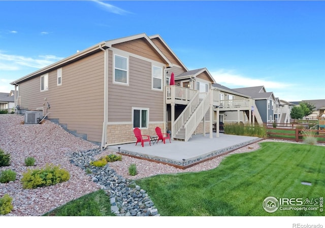 1774 Thrive Dr, Windsor, CO 80550 - back of property with a patio area, a wooden deck, stairs, and a residential view