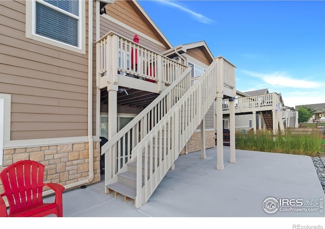 1774 Thrive Dr, Windsor, CO 80550 - view of patio / terrace with a deck and stairs