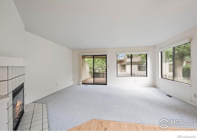 4636 Chestnut Ln, Boulder, CO 80301 - unfurnished living room featuring carpet floors and a tiled fireplace
