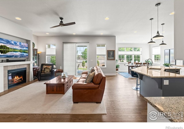 401 Cascade Ct, Johnstown, CO 80534 - living room with ceiling fan, wood finished floors, recessed lighting, and a tiled fireplace