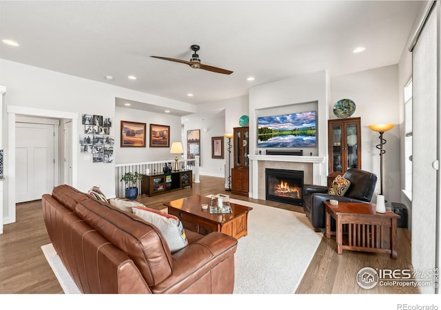 401 Cascade Ct, Johnstown, CO 80534 - living area featuring a tile fireplace, wood finished floors, ceiling fan, and recessed lighting