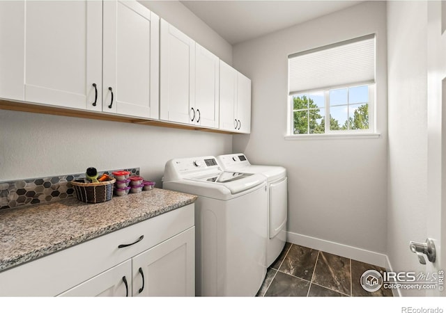 401 Cascade Ct, Johnstown, CO 80534 - washroom with cabinet space, washing machine and clothes dryer, and dark marble finish flooring