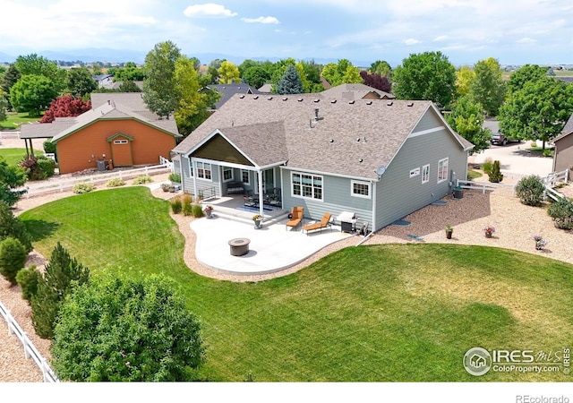 401 Cascade Ct, Johnstown, CO 80534 - rear view of property with a patio, a lawn, and roof with shingles
