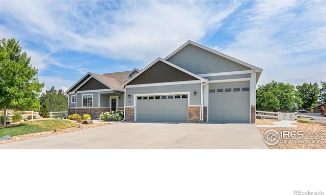 401 Cascade Ct, Johnstown, CO 80534 - craftsman-style house featuring a garage, concrete driveway, and stone siding