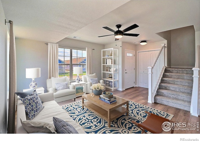 4319 Primrose Ln, Evans, CO 80620 - living room featuring wood finished floors, stairs, a ceiling fan, and a textured ceiling