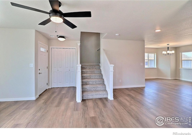 4319 Primrose Ln, Evans, CO 80620 - entrance foyer featuring a chandelier, wood finished floors, stairs, a ceiling fan, and recessed lighting