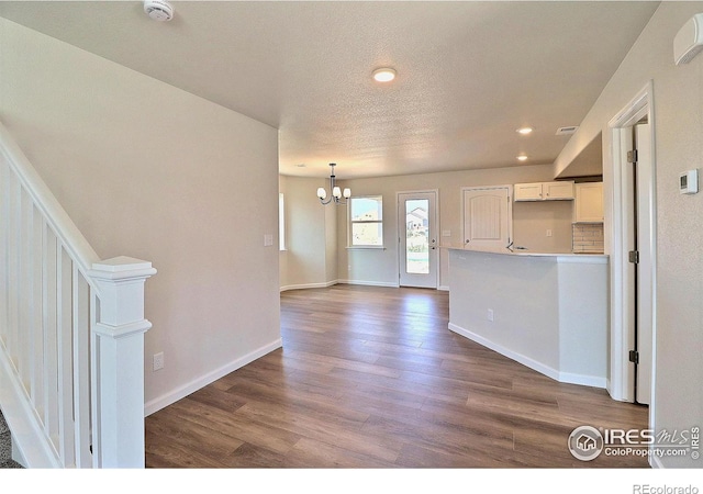 4319 Primrose Ln, Evans, CO 80620 - kitchen with a chandelier, dark wood-style floors, recessed lighting, white cabinetry, and a textured ceiling