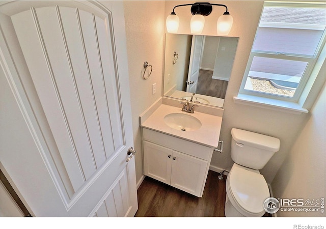 4319 Primrose Ln, Evans, CO 80620 - half bath featuring wood finished floors, vanity, and plenty of natural light
