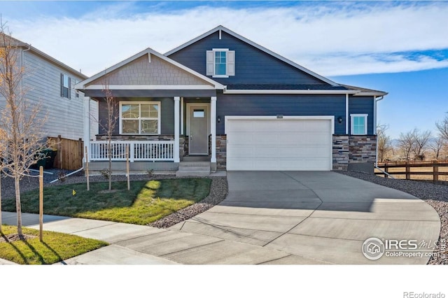 2239 Base St, Fort Lupton, CO 80621 - craftsman-style home featuring covered porch, stone siding, a garage, and concrete driveway