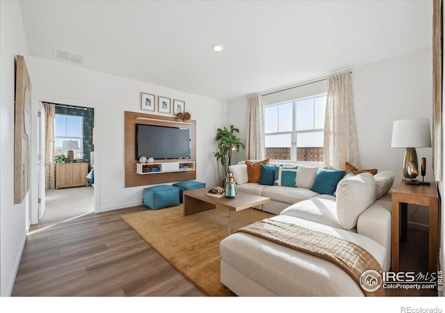2239 Base St, Fort Lupton, CO 80621 - living area featuring wood finished floors and recessed lighting